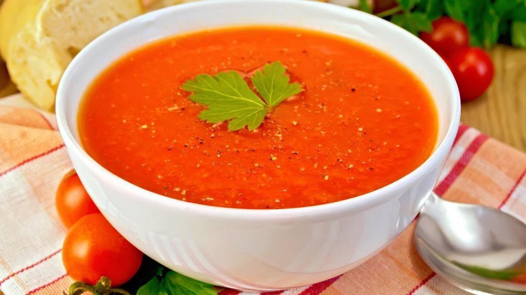 Tomato Roasted Garlic soup · Roasted garlic with tomato soup served piping hot.