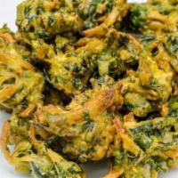 Palak Pakoda · Spinach leaves are coated with spiced gram flour batter and deep fried