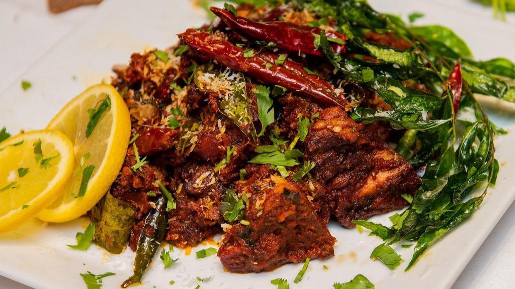 Mutton Sukka Dry · Cooked with a melange of southern spices and Goat meat