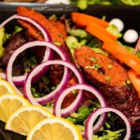 Lamb seekh kabab · Ground lamb is seasoned with fresh mint and cilantro, and indian spicy masala cooked in Tand...