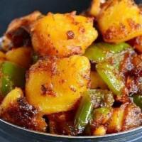 Aloo Capsicum Mutter · Potatoes, capsicum and peas with onion ,tomato gravy spiced with garam masala and cumin powder
