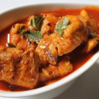 Madras Fish Curry · Fish cooked in spicy gravy with tomato ,onion ,garlic, fenugreek & chili powder