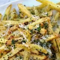 TRUFFLE FRIES · white truffle oil, shaved parmesan and parsley