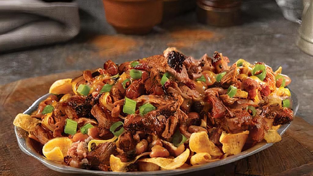 Brisket Chili Frito Pie Stack · A classic combination of Fritos topped with our Brisket Chili, shredded cheddar cheese, and green onions.