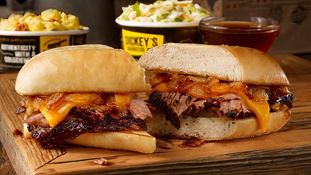Pit Dip Sandwich Plate · Sliced brisket, pit-smoked caramelized onions, & cheddar cheese on a toasted hoagie bun. Served with smoky beef dipping sauce and 2 sides.