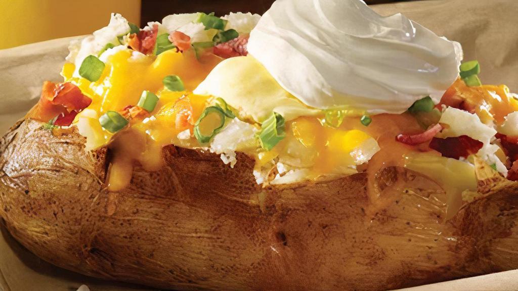 Loaded Giant Baker · A big ole spud filled with your favorite toppings of bacon, cheddar, onions, margarine and sour cream
