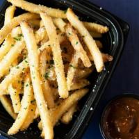 Parmesan Truffle Fries · Crispy fries, dusting of parmesan cheese, truffle oil, sea salt and signature ketchup