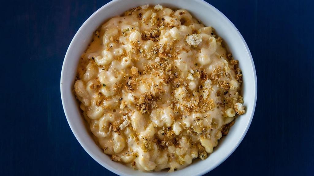 Classic Mac & Cheese Family-Sized · Rich cheddar cheese sauce, touch of cream, parmesan cheese and elbow pasta with baked garlic herb bread topping.