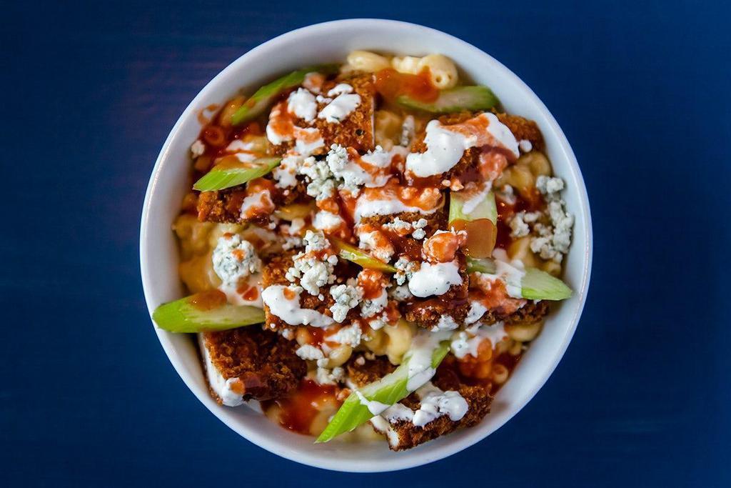 Buffalo Chicken Mac & Cheese · Crispy panko-crusted parmesan chicken, blue cheese crumbles, celery, Frank’s Buffalo Sauce, home-made ranch atop our Classic Mac & Cheese.