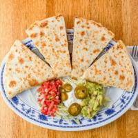 Super Quesadilla · Choice of meat, cheese, Mexican sauce, Sour cream, and guacamole.
