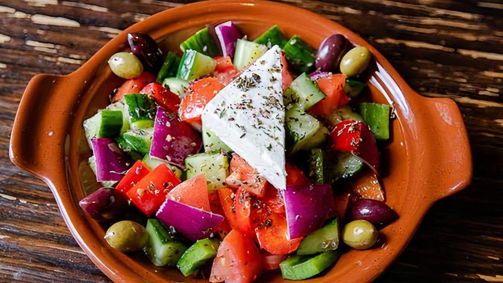 Horiatiki · A freshly mixed salad made with organically tossed Tomatoes, Persian Cucumber, Kalamata Olives, Bell Peppers, Feta, and a traditional spice of Za'atar.