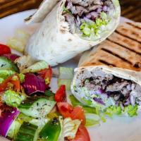 Beef Shawarma Wrap · A traditional Lavash Wrap with a spread of our Housemade Hummus and slowly roasted Beef mari...