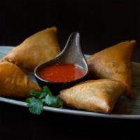 Samosas · Hand-made wheat-flour wraps fried and filled with potatoes onions and spices. served with sp...