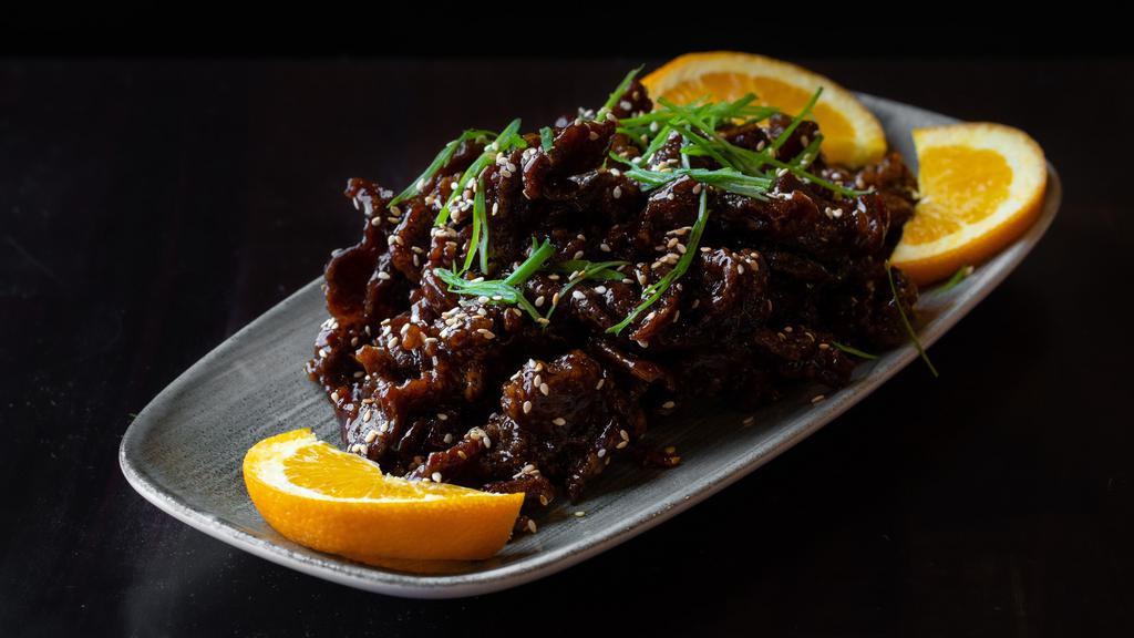 Sesame Beef · Hand-cut strips of beef, lightly fried in soy sauce, vinegar, honey, topped with sesame seeds and scallions.