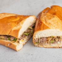 Philly Cheesesteak · Angus sliced beef sautéed in green bell peppers and onions.