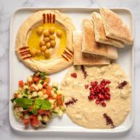 Mezza Platter · A fluffy pita accompanied by hummus, tomato cucumber mix, a drizzle of lemon olive oil dress...
