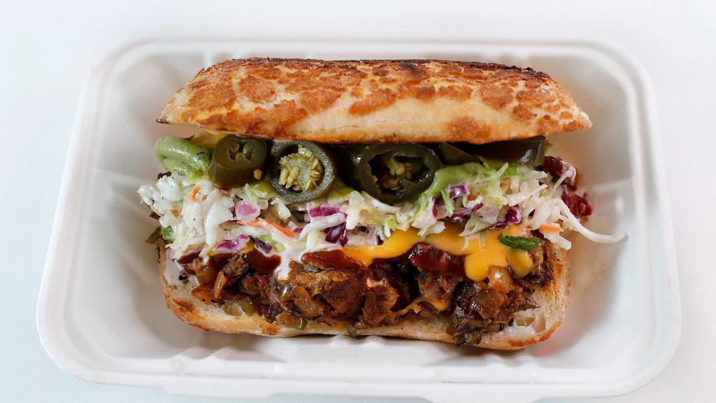 Da Divisadero aka Not - Yo - Cheesesteak · Plant-based brisket with grilled onions and colorful bell peppers on a soft roll with melted cheese and nacho cheese topped with Tasha's slaw, guacamole, and jalapeños.