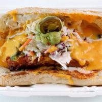 Mob Link Sandwich · Smoked plant-based link topped with nacho cheese, mob sauce, Tasha's slaw, jalapenos, and gu...