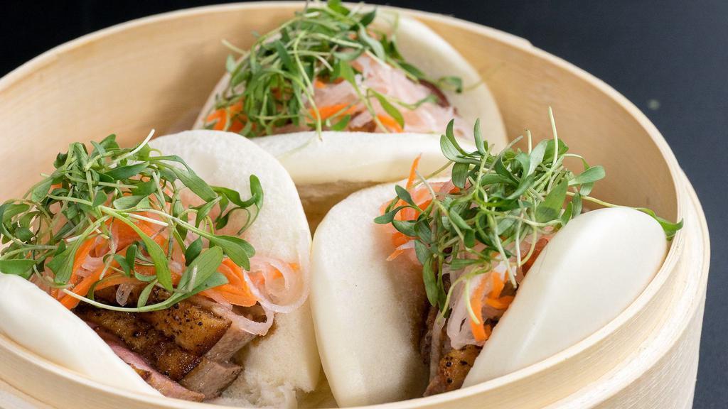 Duck Baos (2) · Duck breast, pickled daikon, and carrots, micro cilantro, hoisin-ginger sauce, steamed buns.