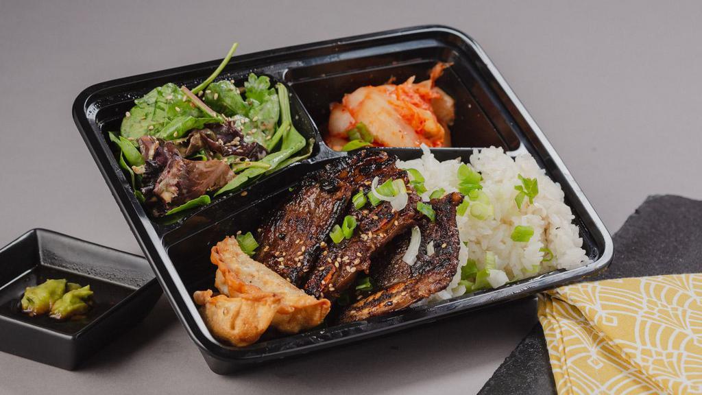 Korean Short Ribs Bento Box · A bento box with korean short ribs and your choice of either white rice or chow mein noodles with 2 sides.