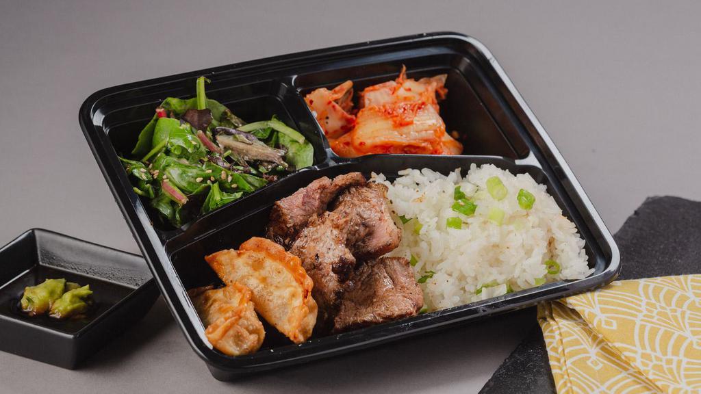 Grilled Sliced Steak Bento Box · A bento box with grilled sliced steak and your choice of either white rice or chow mein noodles with 2 sides.