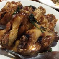 Angel Wings · Fried chicken wings covered in a sweet and sour tamarind sauce.