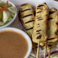 Chicken Satay · Grilled chicken skewers served with peanut sauce and cucumber salad.