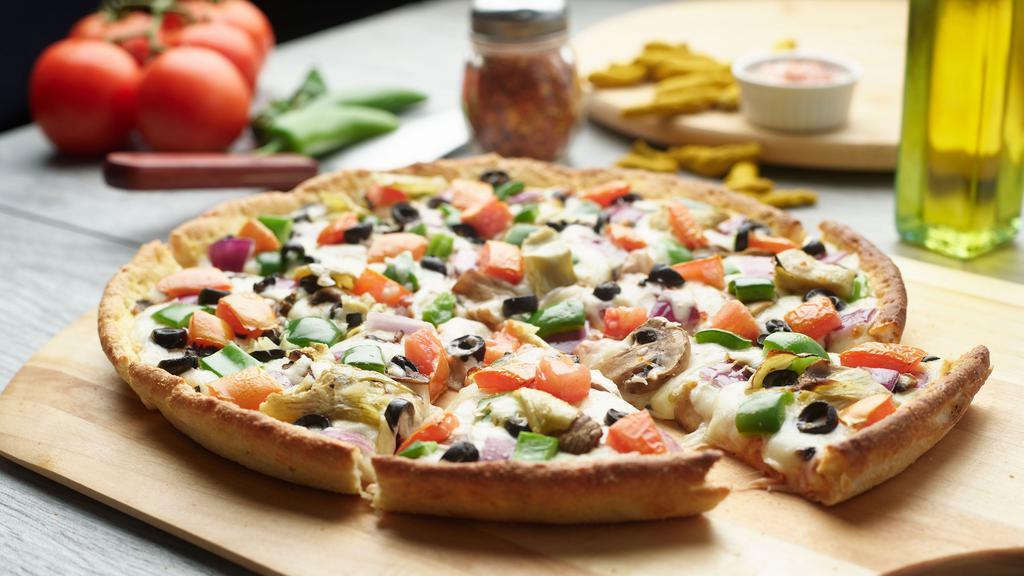 Vegan Combination Pizza Twist · This pizza has our signature vegan red sauce, signature vegan cheese, sliced vegan pepperoni, fresh mushrooms, crisp red onions, sliced black olives, fresh green pepper & vegan chicken.