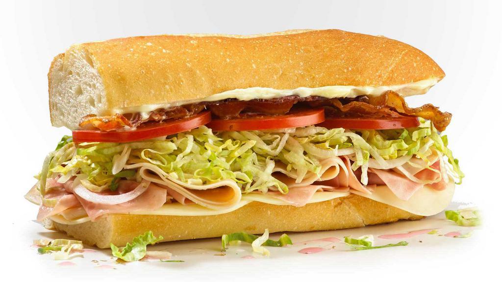 #8 Club Sub · Provolone, applewood smoked bacon, ham and raised without antibiotics turkey, mayo. Served Mike's Way with onions, lettuce, tomato, vinegar, oil, oregano, and salt.