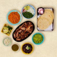 Carnitas Taco Kit · 1 pound of protein, 12 corn tortillas, mexican rice, chopped onions, cilantro, shredded chee...