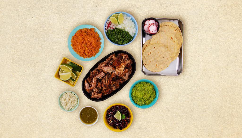 Carnitas Taco Kit · 1 pound of protein, 12 hand-made corn tortillas, mexican rice, chopped onions, cilantro, shredded cheese, salsa verde, limes.