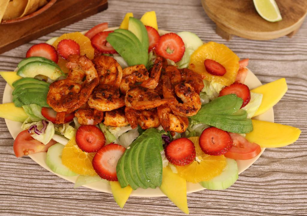 Ensalada de Camaron · 10 savory grilled jumbo shrimps, served on top of salad, avocado, cucumber, mango and strawberries.