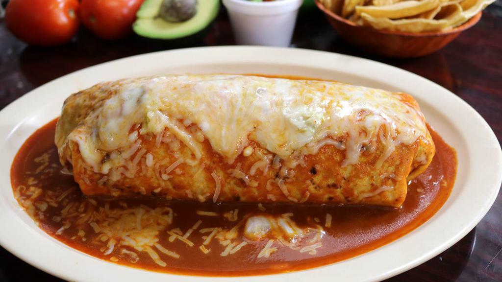 Super Burrito Mojado · A 14” Flour tortilla covered with our homemade and delicious tomato sauce, stuffed with rice, whole beans, cheese, pico de gallo, fresh guacamole, sour cream, and your choice of meat.