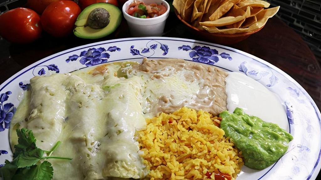 ENCHILADAS VERDES · three rolled corn tortilla with your choice of meat, topped with our tasty homemade green tomato sauce and cheese, served with salad, refried beans, fresh guacamole and sour cream