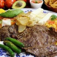 Carne Asada · tender grilled steak ball tip beef lightly spiced served with salad, refried beans, rice, fr...