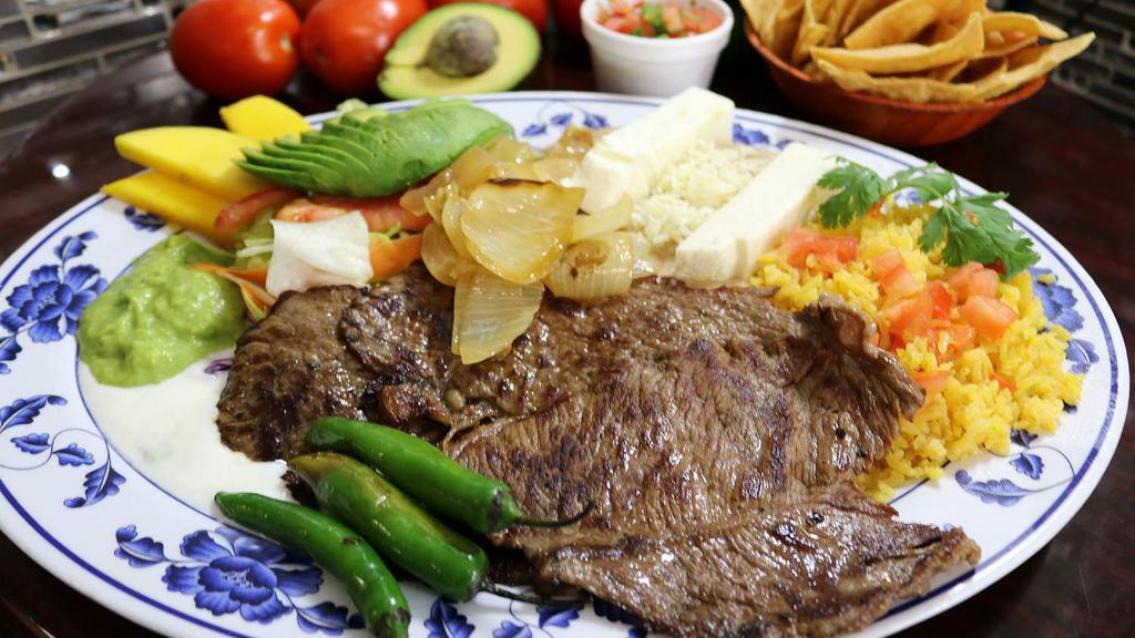 Carne Asada · tender grilled steak ball tip beef lightly spiced served with salad, refried beans, rice, fresh guacamole and sour cream.