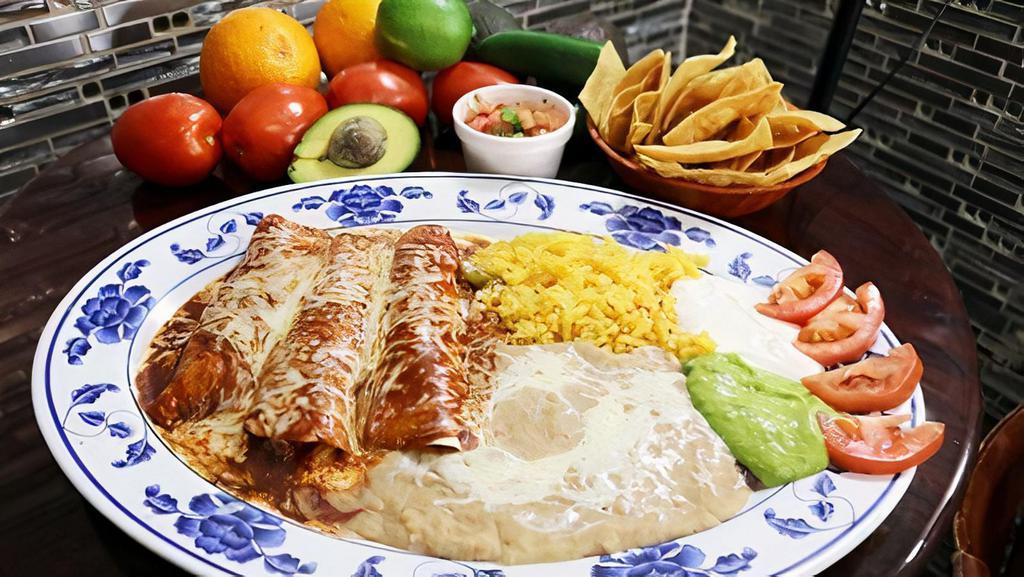 ENCHILADAS ROJAS · three rolled corn torilla filled with your choice of meat, topped with our tasty homemade mole recipe and cheese, served with salad, rice, refried beans, cheese, fresh guacamole and sour cream