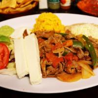 Steak Ranchero · Delicious thin steak slices grilled with fresh jalapeño, onion and tomato served with salad,...