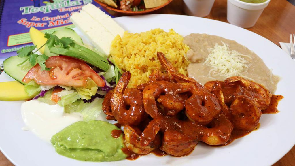 Camarones a La Diabla · Fresh shrimp sautéed with homemade hot sauce, served with salad, rice, refried beans, cheese, fresh guacamole, and sour cream.