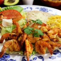 Camarones a La Plancha · Fresh shrimp grilled to tenderness, sautéed with our special mild spicy sauce, served with s...