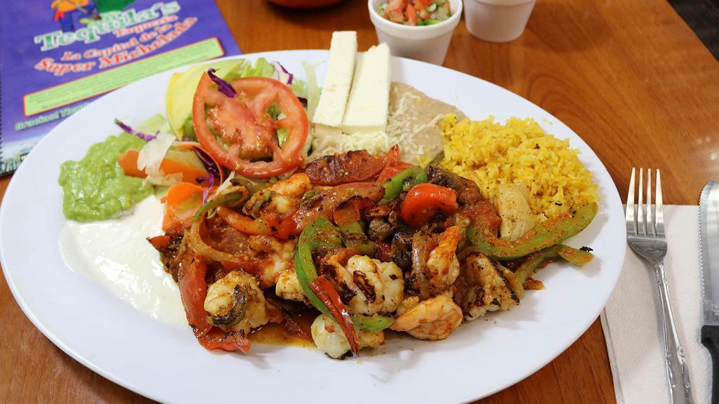 Fajitas De Camaron · Fresh savory shrimp slightly spiced and cooked with red and green bell pepper, onion and tomato, served with salad, refried beans and rice, fresh guacamole, and sour cream.