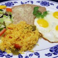 Huevos Rancheros · Three over-easy eggs, topped with homemade tomato sauce, served with rice and refried beans ...