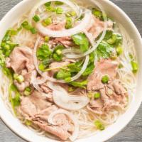 P1- Pho Tai · Beef rice noodle soup with thinly sliced Rare Filet Mignon and a side of fresh herbs (includ...