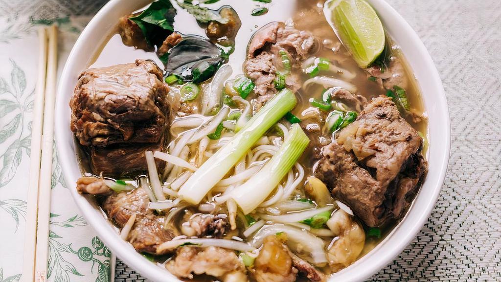 P0- Pho Duoi Bo · Beef rice noodle soup with braised Oxtail and a side of fresh herbs (includes bean sprouts, basil, jalapeño slices, and limes).