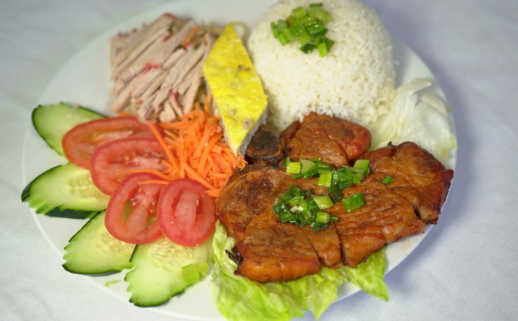 Com Tam, Suon, Bi, Cha · Grilled pork chop, julienne pork skin and meat pie. Served with lettuce, tomatoes, cucumber and house sauce.