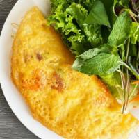 52. Banh Xeo · Crispy pan-fried crepe filled with shrimp, onions, bean sprouts, fresh lettuce and herbs and...