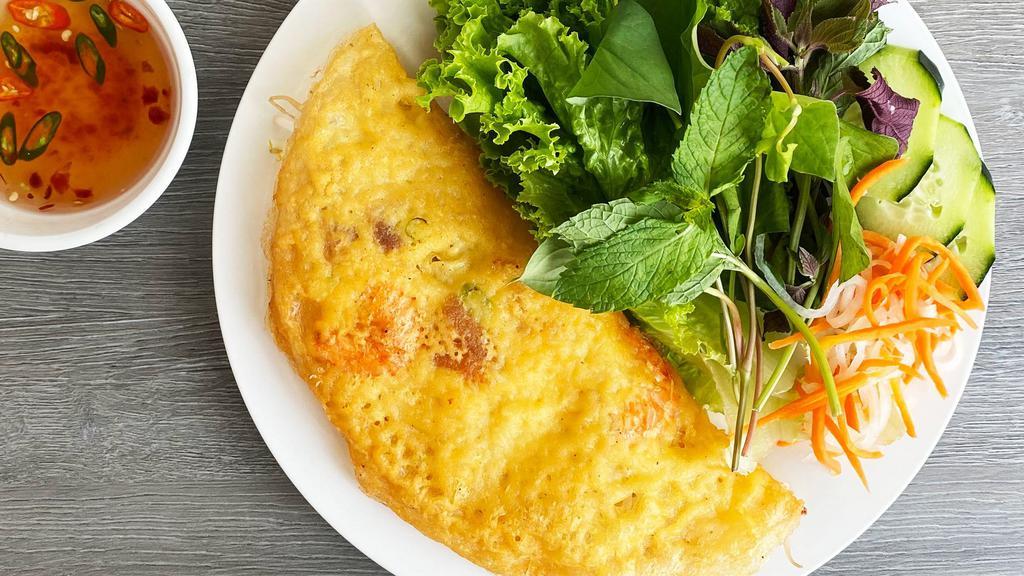 52. Banh Xeo · Crispy pan-fried crepe filled with shrimp, onions, bean sprouts, fresh lettuce and herbs and our famous house dipping sauce