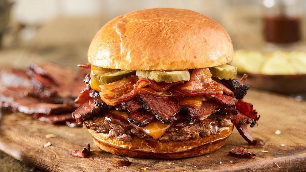 Smoked Bacon Brisket Burger · Certified Angus Beef, smoked aged cheddar cheese, brisket, applewood smoked bacon, pickles, bbq sauce, toasted brioche bun