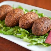 Fried Kebbe (4 Pieces) · Seasoned lamb stuffed with pine nuts, in cracked wheat with beef.