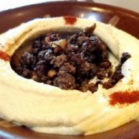 Hummus with Meat · Chickpea purée, tahini sauce, garlic and lemon juice topped with meat and pine nuts.